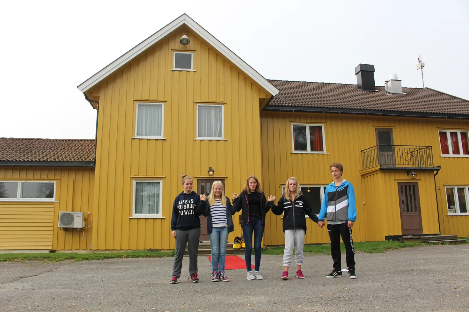 Haraset fasade med barn utenfor